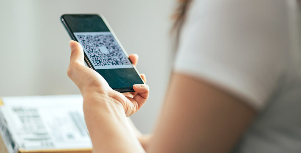 women scanning qr code from mail parcel package